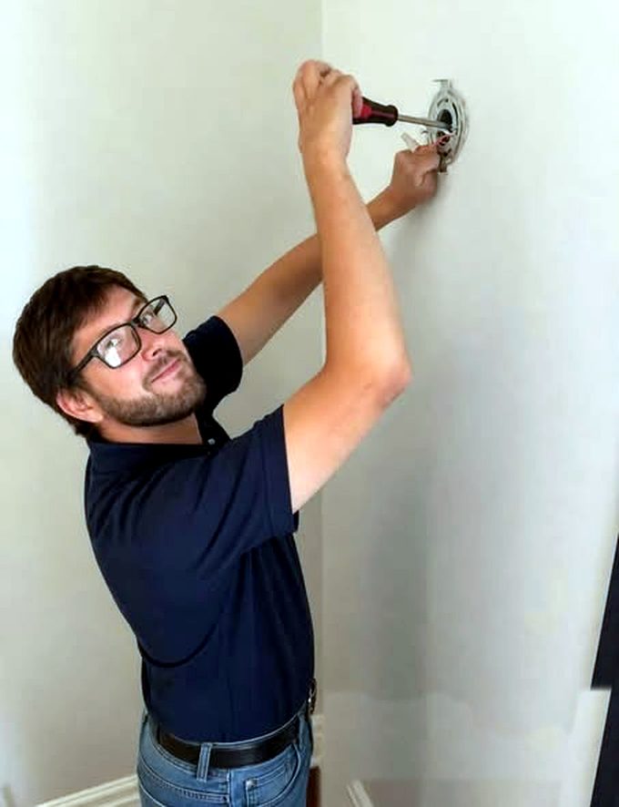 Handy Home crew member installing a light fixture